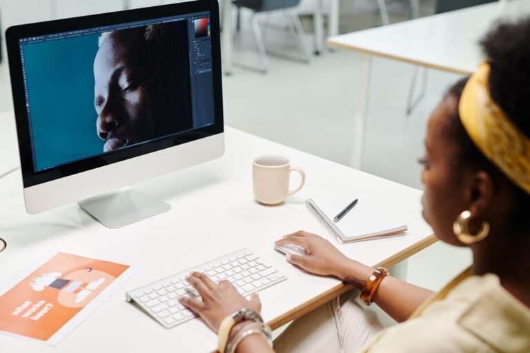 Designer editing visuals on a desktop computer